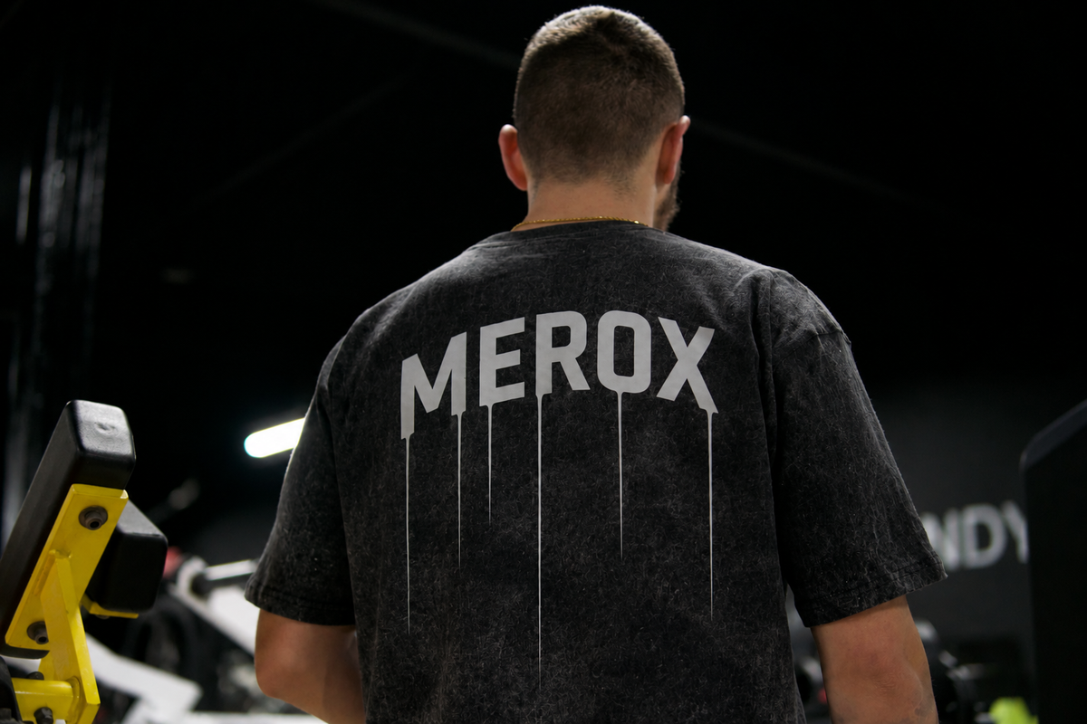 Male model wearing MEROX black and white acid wash T-shirt in a gym