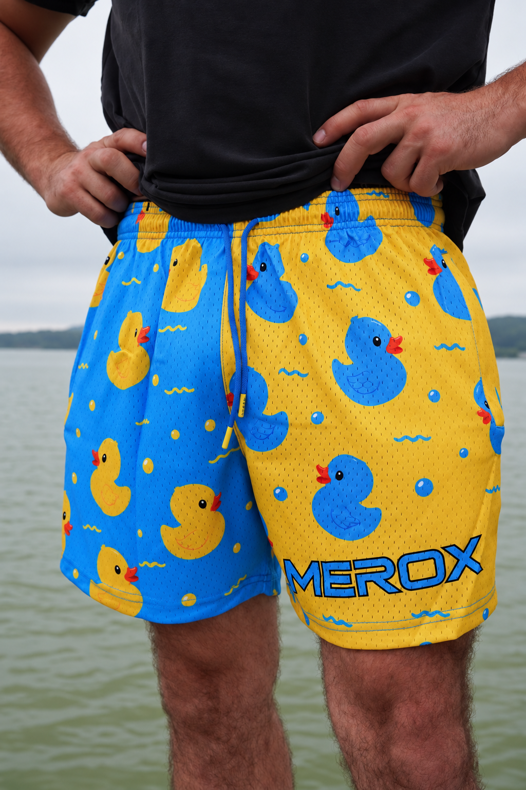 Man wearing MEROX blue and yellow duck print mesh shorts