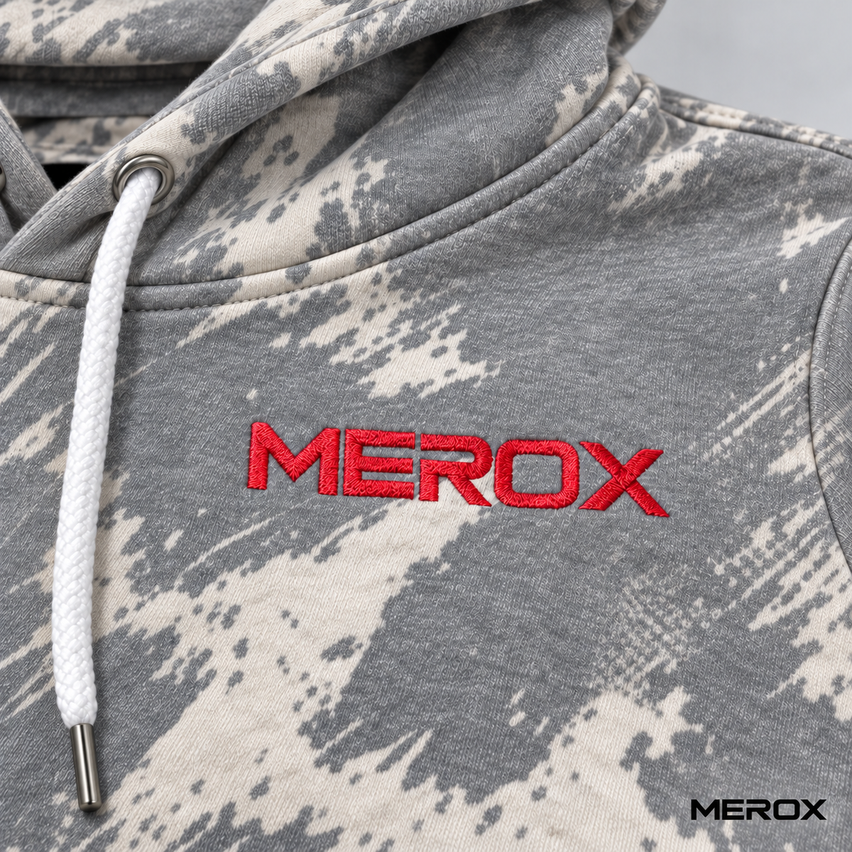 Red embroidered MEROX logo on black scratch camo hoodie